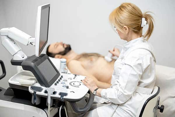 Doctor examines liver health of a male patient